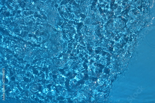 Foto Blue and bright water surface with sun refection in swimming pool for background