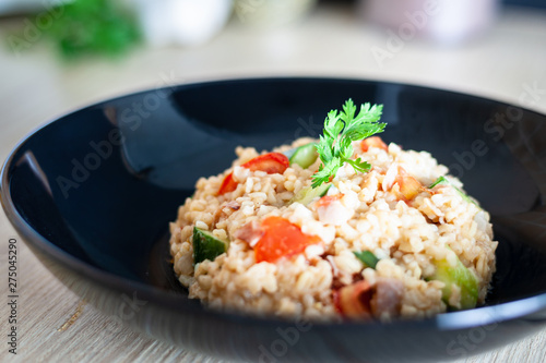 Bulgur salad with vegetables on the kitchen table with ingredients. Arabic couscous salad.