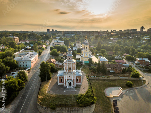 Aerial view of the ancient Orthodox Christian monastery, located among the houses and nature in the city of Serpukhov. Early summer morning. Moscow region