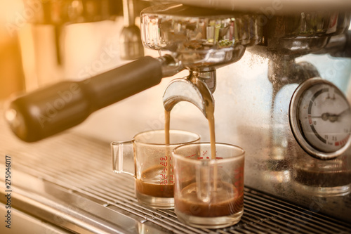 Coffee Machine pouring coffee to a cup.