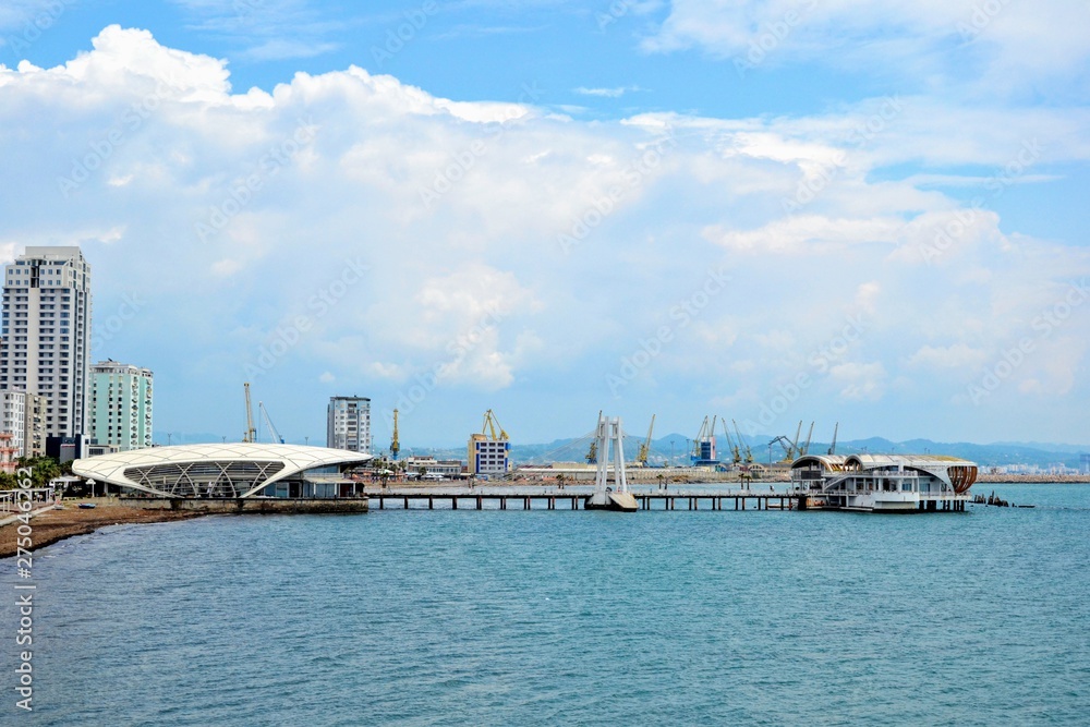 Durres, Albania - June 5 2019: Embankment at Durres city. Waterfront promenade, boulevard of Durres with bars, restaurants, hotels and residences. Ventus Harbor in the distance Durres, Albania - June 5 2019: Embankment at Durres city. Waterfront promenade, boulevard of Durres with bars, restaurants, hotels and residences. Ventus Harbor in the distance