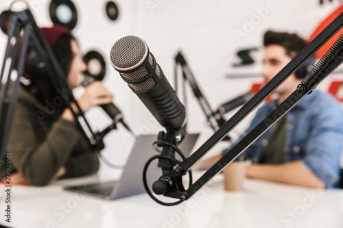 Two radio hosts moderating a live show photo