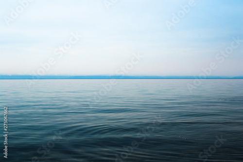 Lake Baikal on a sunny day. Clear blue sky and water. Free space for text. Background for design  screen saver