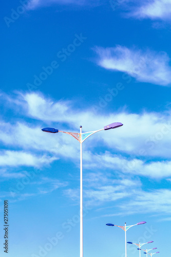 Outdoor blue sky with white clouds and street lights
