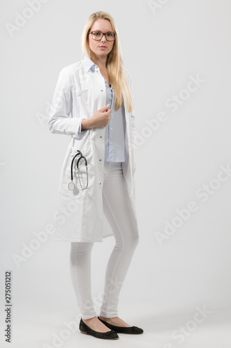whole body picture of young female doctor in lab coat with stethoscope