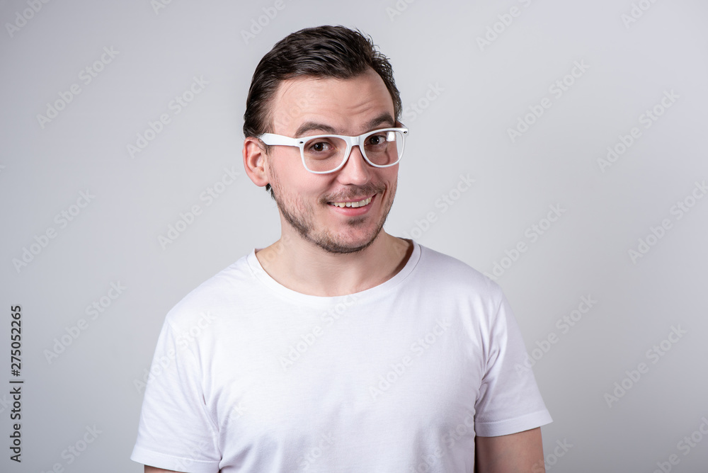 Handsome man with bristles and glasses smiling on a white background Handsome man with bristles and glasses smiling on a white background