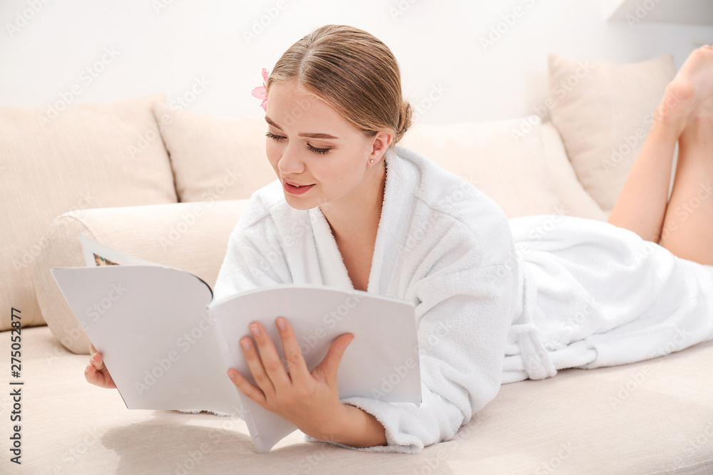 Beautiful young woman reading magazine in spa salon Beautiful young woman reading magazine in spa salon