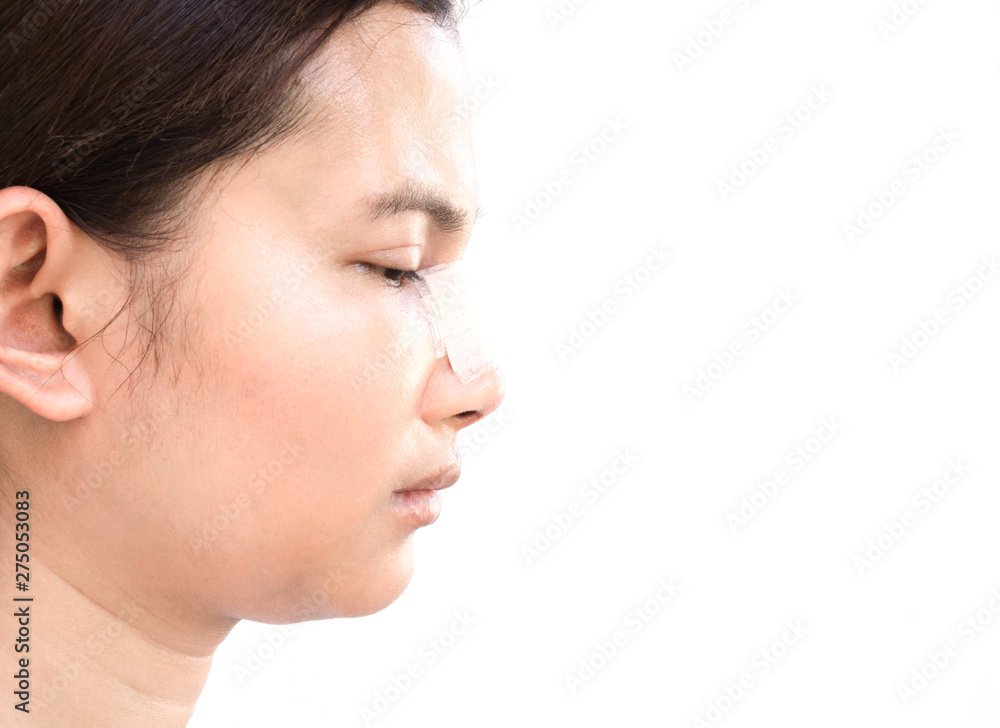 Close up face of asian woman with nose plastic surgery for beauty and cosmetic concept, white background Close up face of asian woman with nose plastic surgery for beauty and cosmetic concept, white background