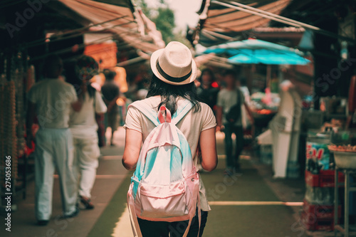 asian woman tourist with backpack travel in market of thailand