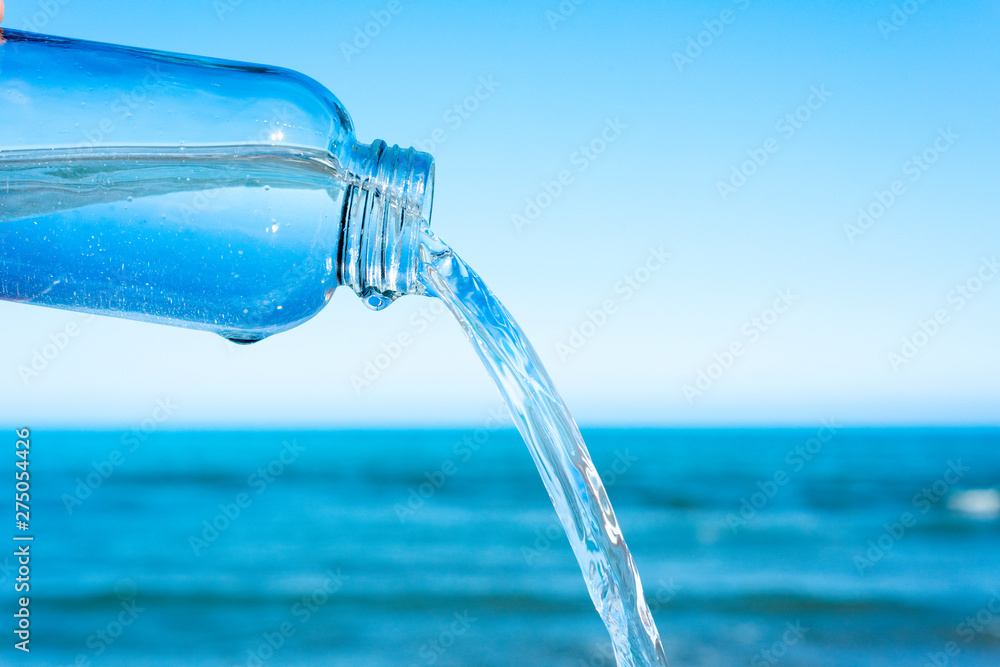 water flowing out of a glass reusable bottle water flowing out of a glass reusable bottle