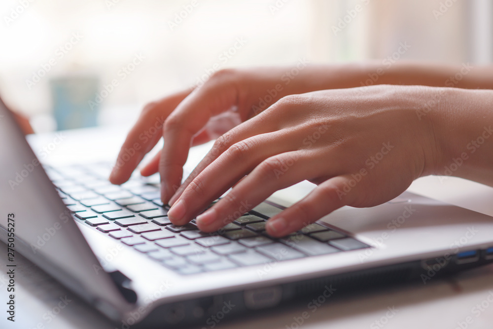 Woman working at home office hand on keyboard close up Woman working at home office hand on keyboard close up