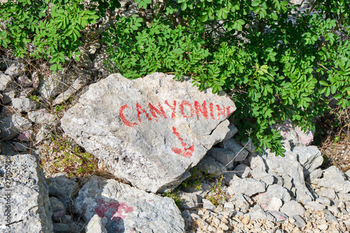 Canyoning sign on a stone, written in red, just above Cikola river, in Croatia. Adventure concept. photo