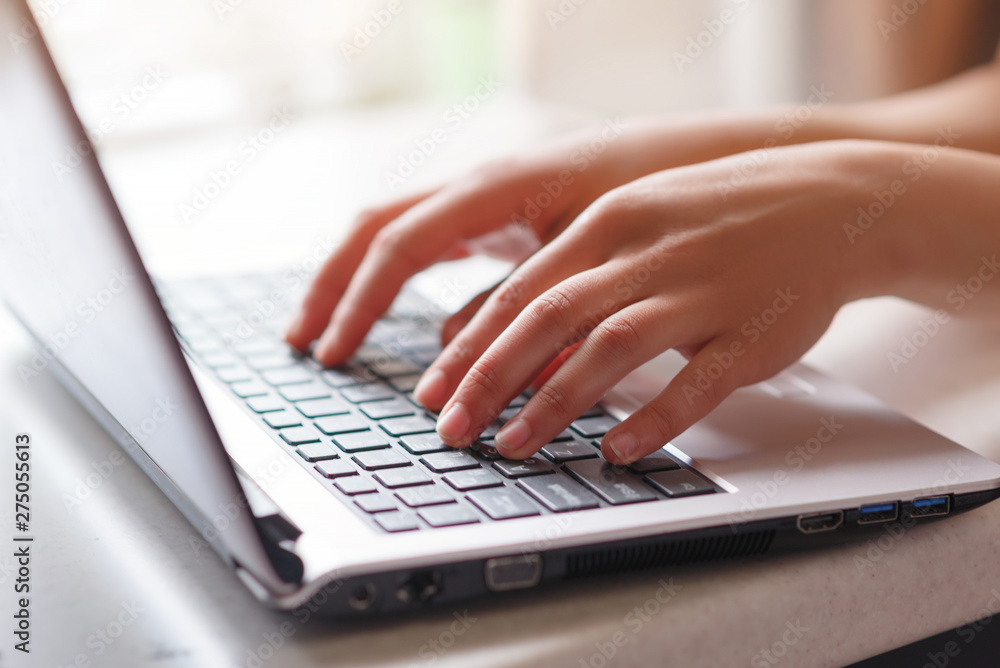 Woman working at home office hand on keyboard close up Woman working at home office hand on keyboard close up