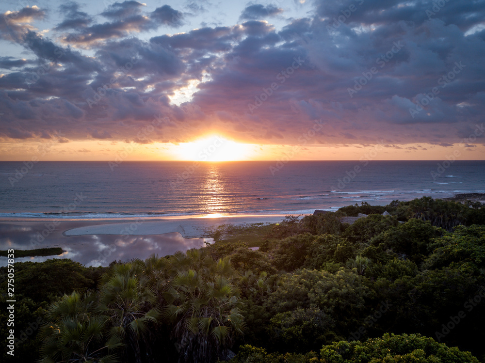 Sunrise above the Indian ocean and the forest.