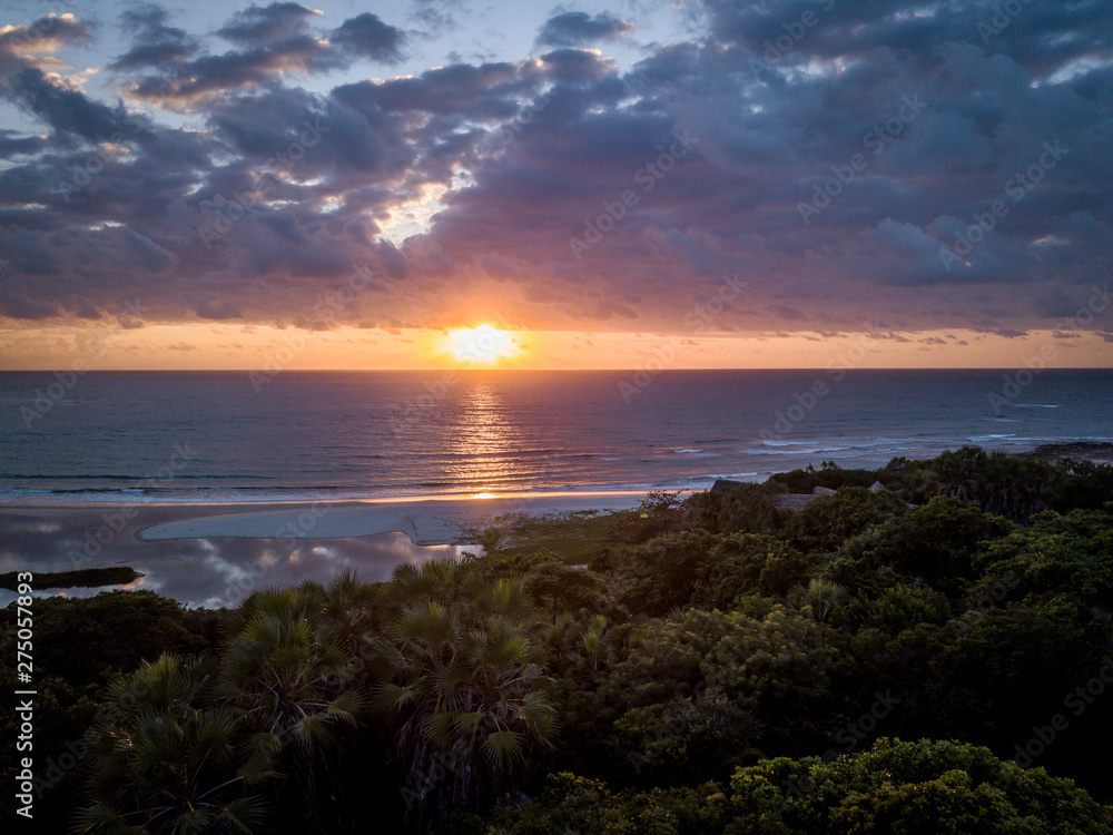 Sunrise above the Indian ocean and the forest.