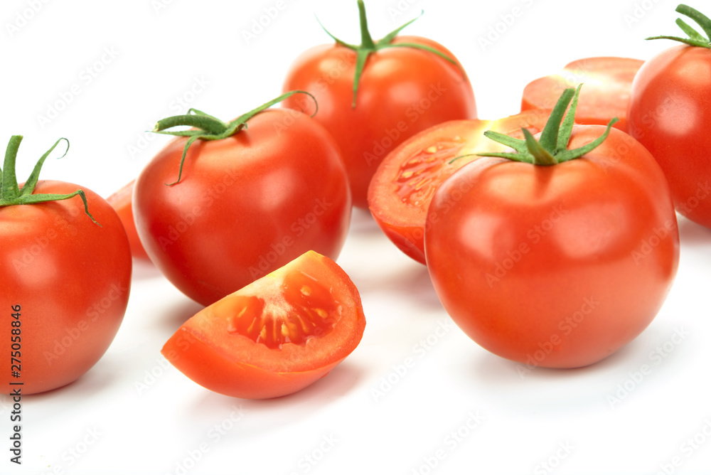 Group of whole and sliced tomatoes isolated on a white background in close-up Group of whole and sliced tomatoes isolated on a white background in close-up