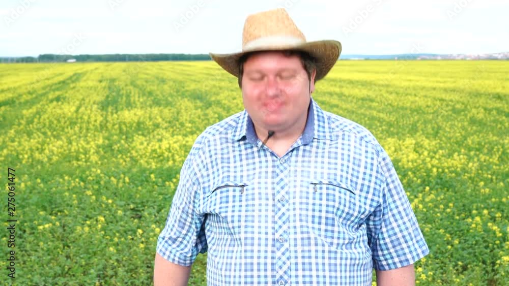 Farmer standing in field and shaking his head, says yes, in the field on a sunny day Farmer standing in field and shaking his head, says yes, in the field on a sunny day