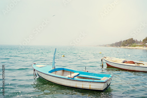 Beautiful landscape with seashore and fishing boat. © luengo_ua