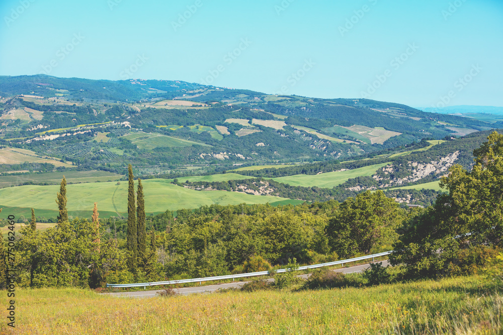 Beautiful landscape, spring nature. View from above of sunny fields on rolling hills in Tuscany, Italy