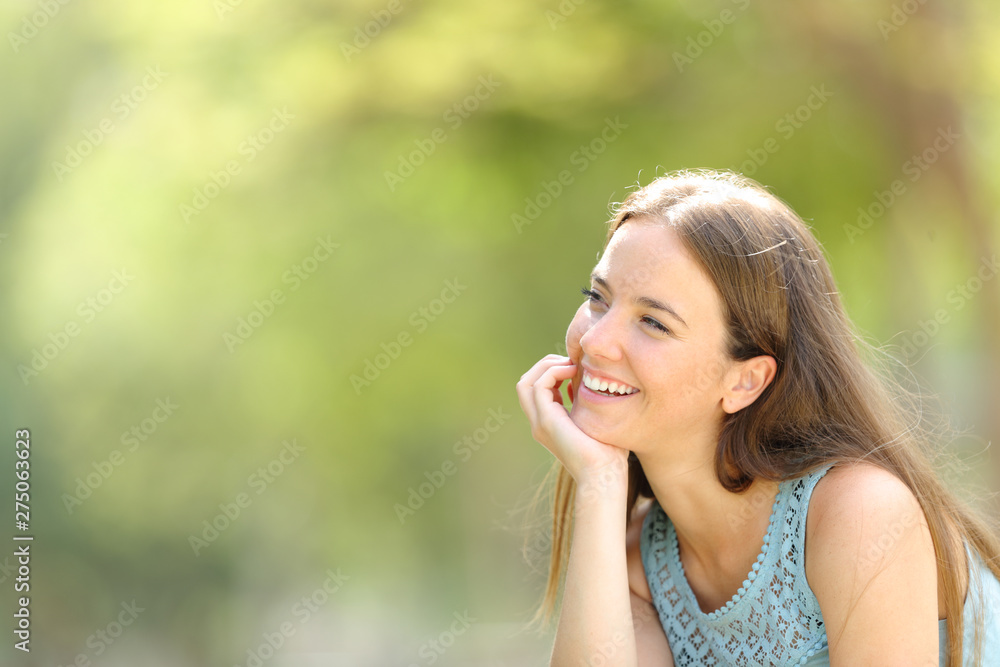 Happy dreamer dreaming in a park with a green background Happy dreamer dreaming in a park with a green background