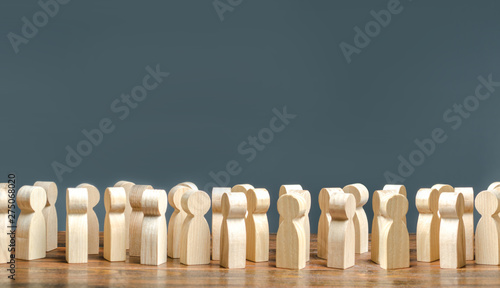 A crowd of wooden figures of people. society, demography. group of citizens, rally, political movement or electorate. Customers and buyers, statistics, preferences of Population. Employees. Copy space photo