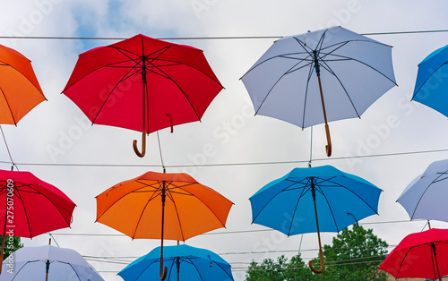 Colorful umbrellas in the sky. Street decorations from multicolored umbrellas.