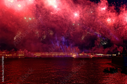 Fototapeta Naklejka Na Ścianę i Meble -  Fireworks over the water Holiday light. Night cityscape scene. Neva river, Saint-Petersburg, Russia. Holiday Scarlet Sails.