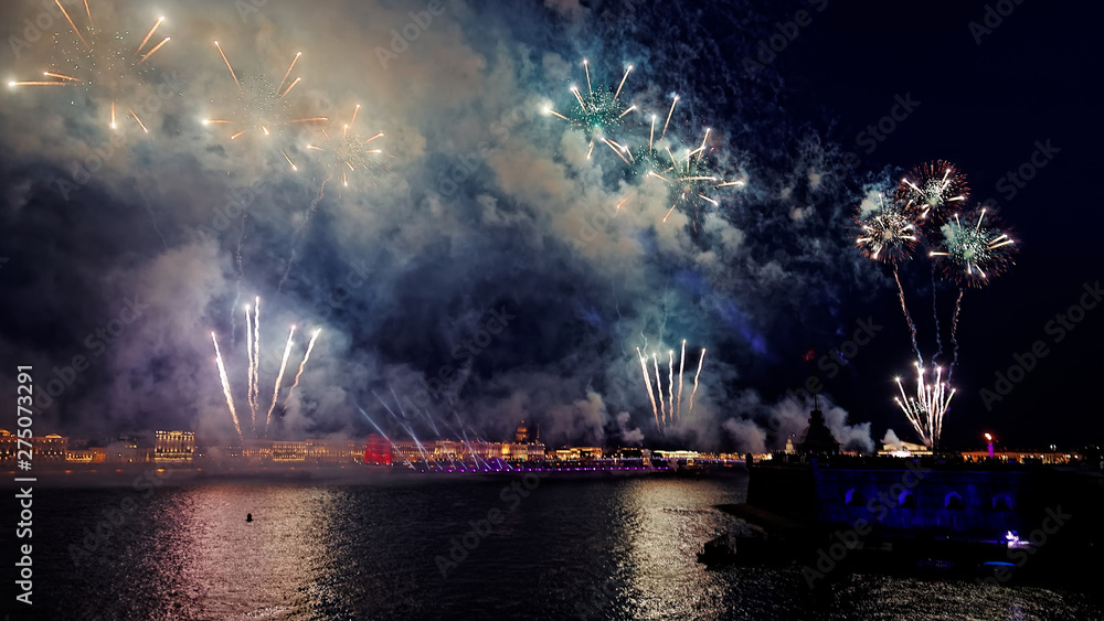Fireworks over the water Holiday light. Night cityscape scene. Neva river, Saint-Petersburg, Russia. Holiday Scarlet Sails.