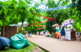 Beautiful bokeh background of the festival in the green city park.