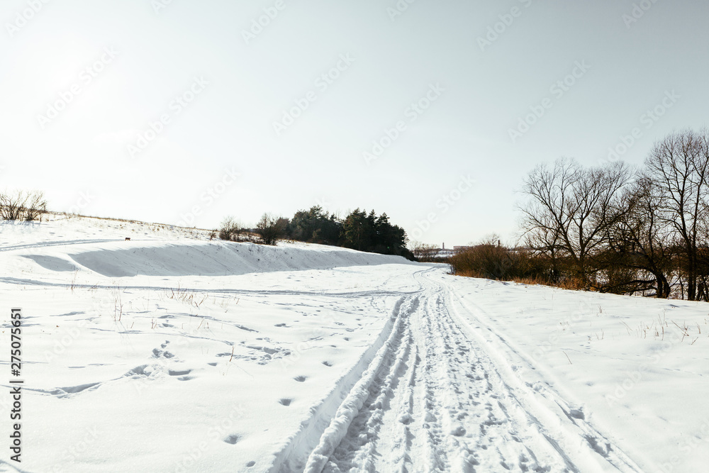 Cross country ski tracks on snowy landscape in winter Cross country ski tracks on snowy landscape in winter