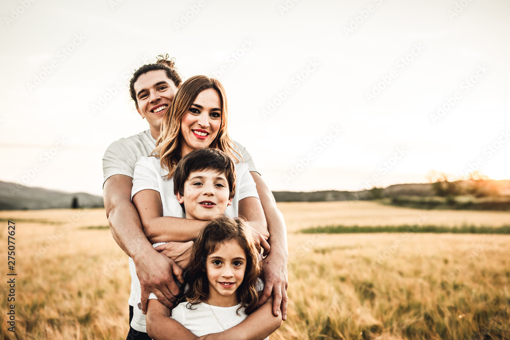 Portrait of a happy young family smiling in the countryside. Concept of family fun in nature. Portrait of a happy young family smiling in the countryside. Concept of family fun in nature.