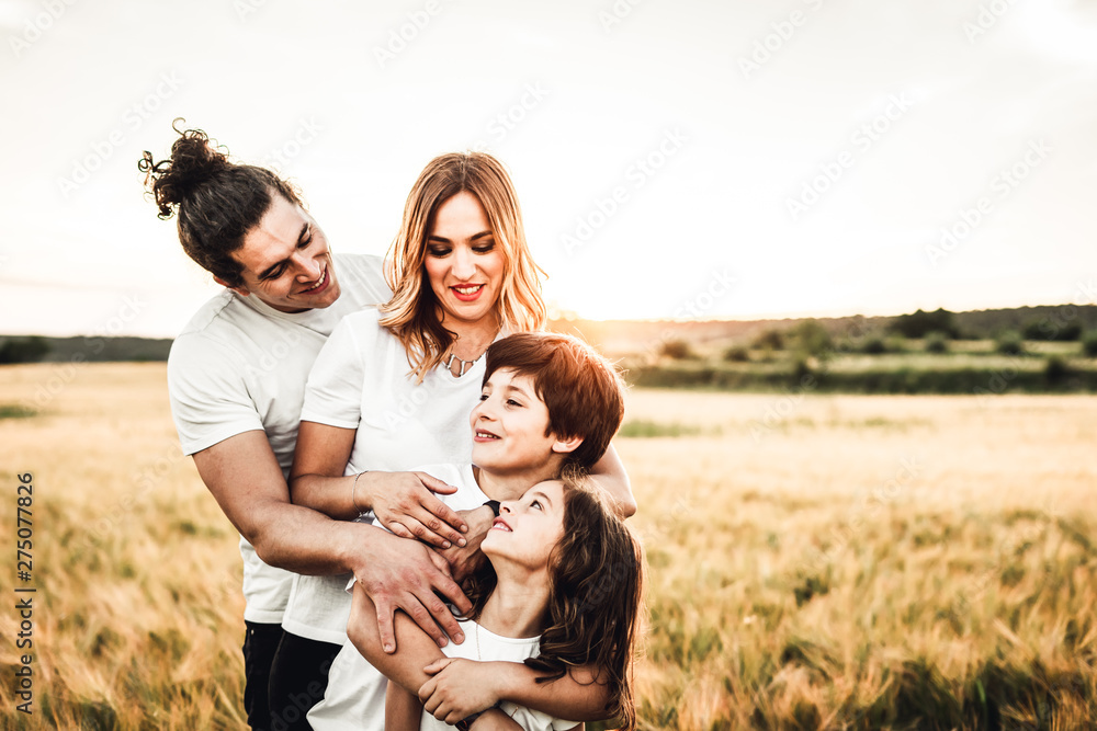 Portrait of a happy young family smiling in the countryside. Concept of family fun in nature. Portrait of a happy young family smiling in the countryside. Concept of family fun in nature.