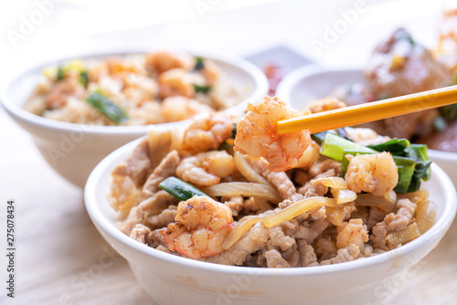 Braised shrimp over rice - Taiwan famous traditional street food. Soy-stewed prawn and sliced pork on cooked rice. Travel concept, copy space, close up