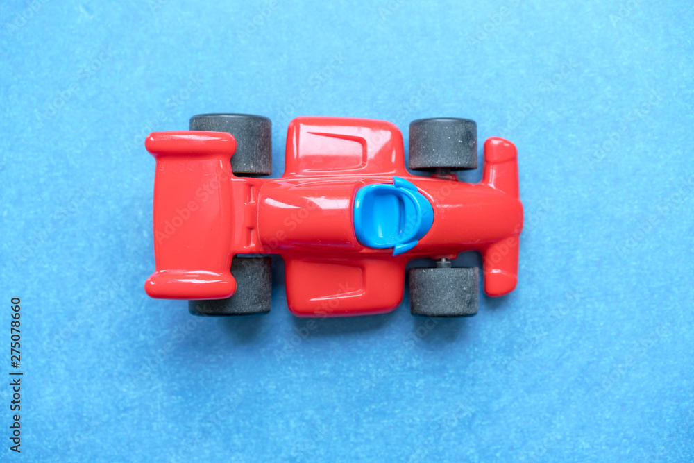Fototapeta premium red plastic toy racing car with big wheels