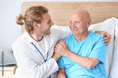 Doctor with elderly man in ...