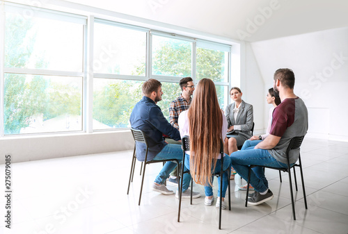 Young people with psychologist at group therapy session