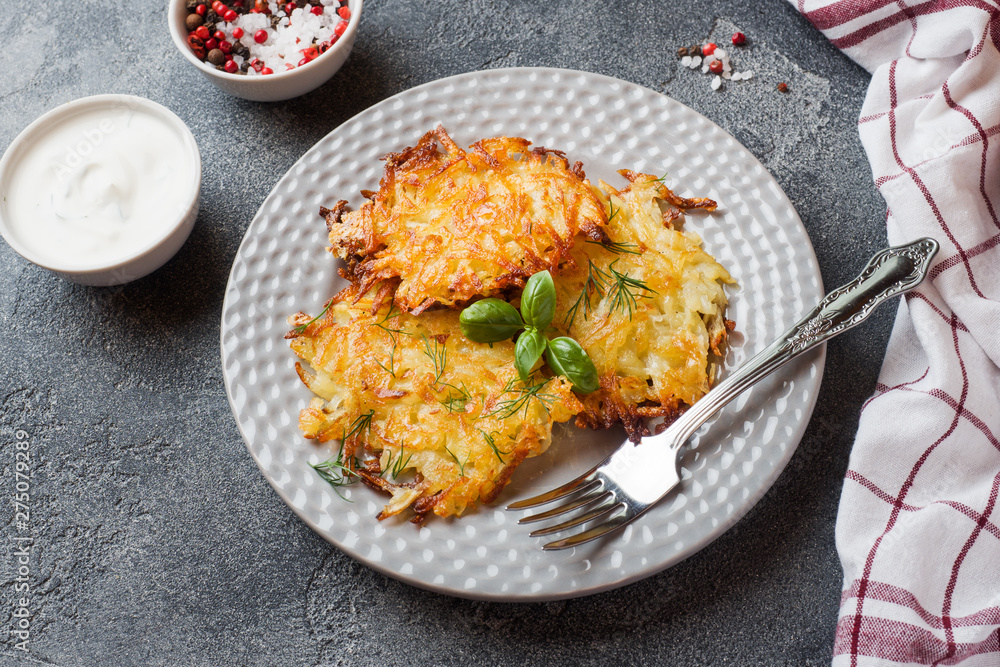 Fried cakes of grated potatoes on the plate with sauce. Traditional pancakes boxty raggmunk Fried cakes of grated potatoes on the plate with sauce. Traditional pancakes boxty raggmunk