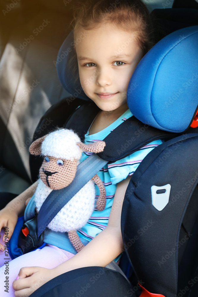 Little girl buckled in car safety seat