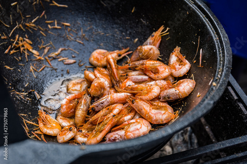 Shrimps fried in a frying pan wok