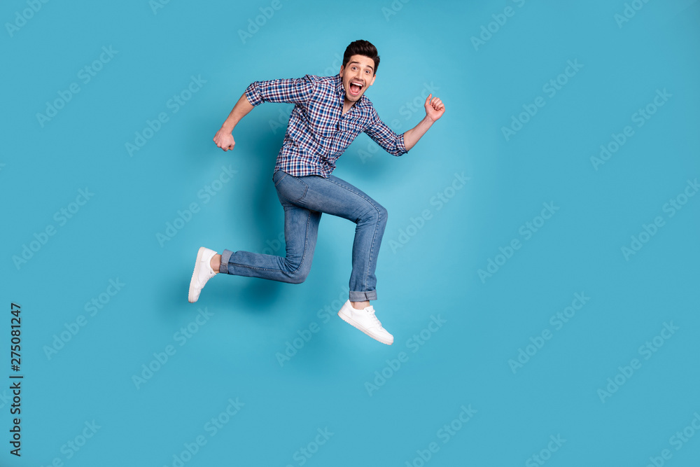 Full length body size view photo handsome cute millennial shout wow omg unbelievable unexpected fan free time holidays weekend wear checkered shirt denim sneakers isolated blue background
