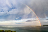 Stunning big rainbow after the rain over the sea