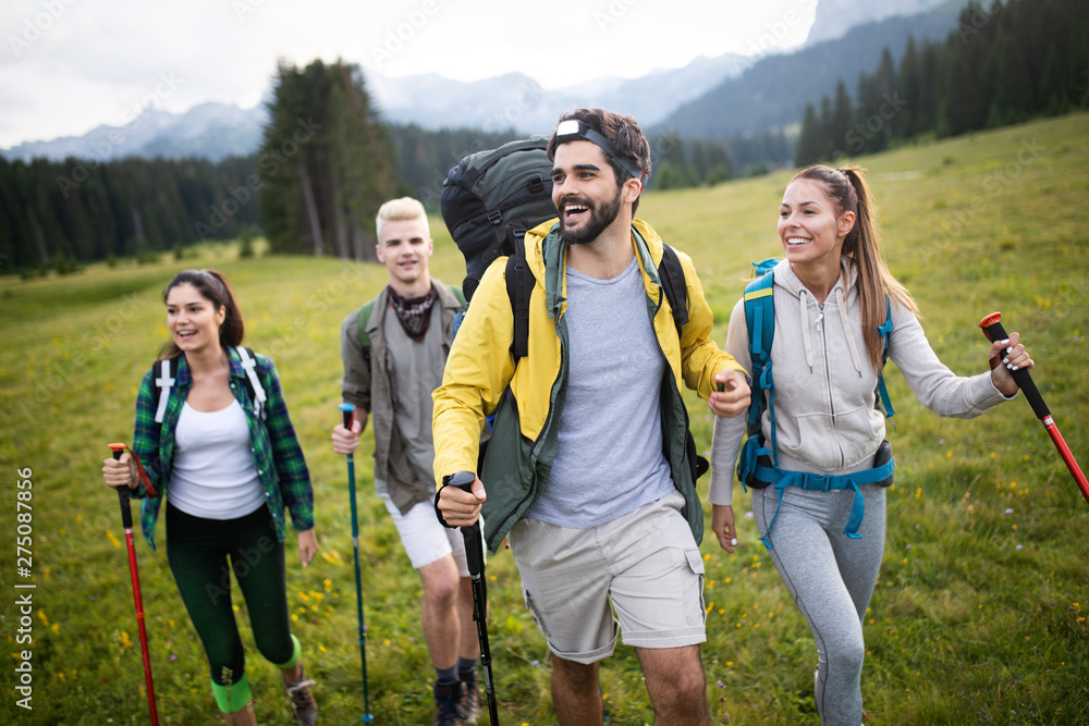 Group of friends on a mountain. Men and women climbing rocks. Group of friends on a mountain. Men and women climbing rocks.