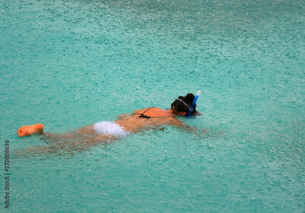 Swimming in a mask in the Maldives in the rain