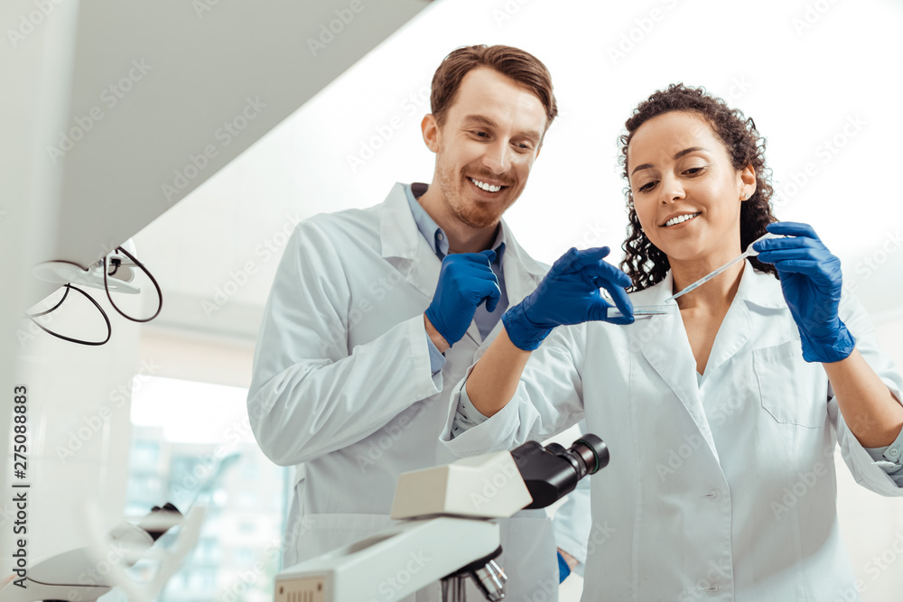 Happy positive biologists conducting a successful research Happy positive biologists conducting a successful research
