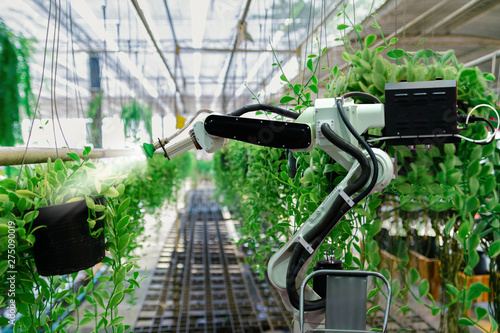 Obraz na płótnie Automatic agricultural technology robot arm watering plants tree w salonie
