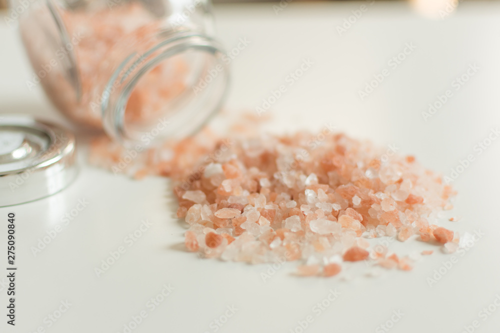 Pink sea salt on white background. Hip of red himalaya salt on white. Pink sea salt on white background. Hip of red himalaya salt on white.