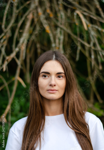 A beautiful girl with dark long hair. Summertime photo