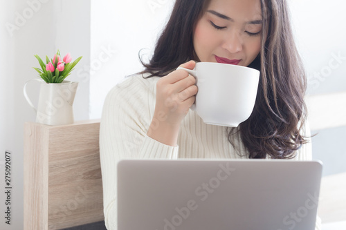 Young beauty Asian woman using computer at home.