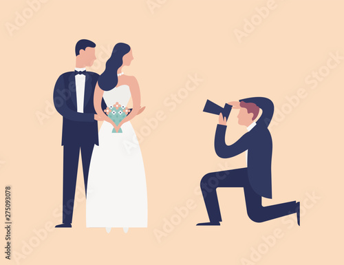 Lovely newlyweds standing together and posing for photographer shooting them