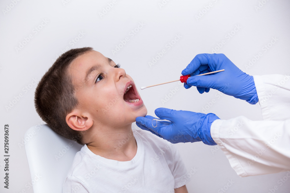 Close-up view doctor hands in gloves using cotton swab to test young boy for bacterial infections Close-up view doctor hands in gloves using cotton swab to test young boy for bacterial infections